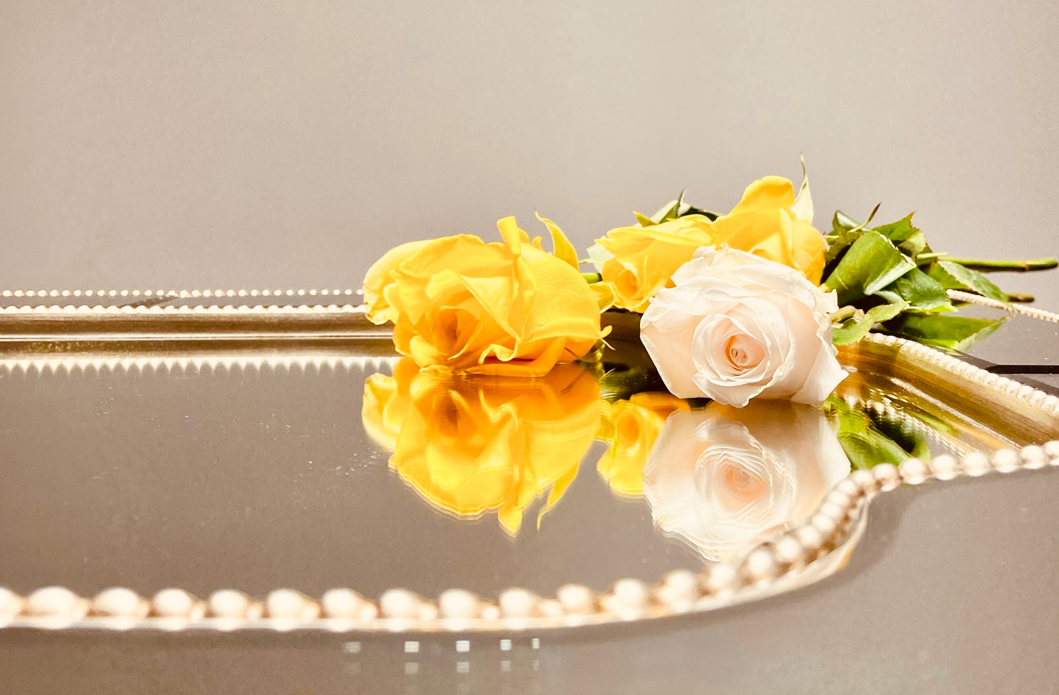 Yellow and White Roses on a Mirror